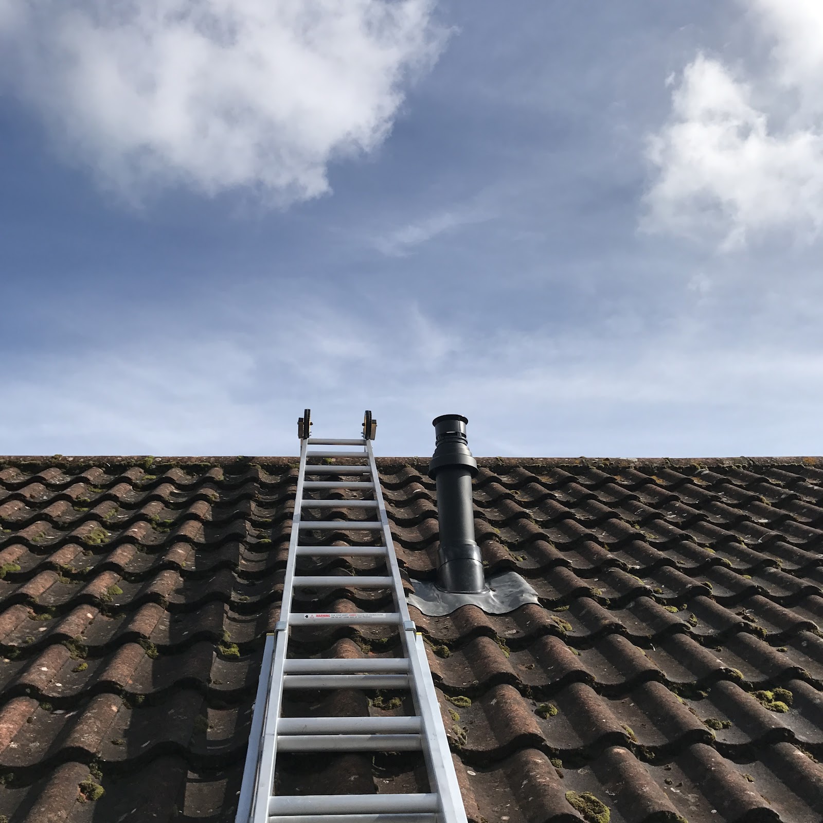 A new boiler flue terminated cleanly through a tiled roof — the sort of detail an accredited installer gets right.