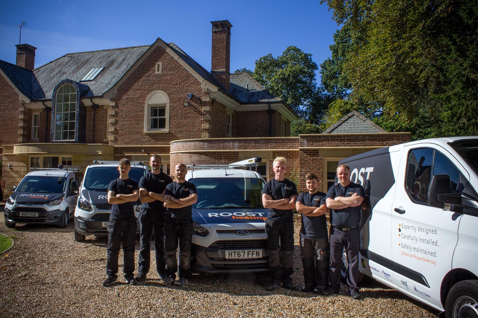 The Roost team and fleet outside a Hampshire home — directly employed, DBS-checked engineers you'll get to know by name.